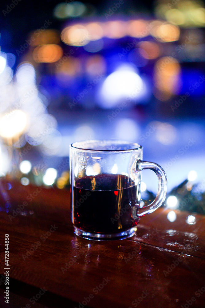 Gluhwein on wooden table with bokeh background