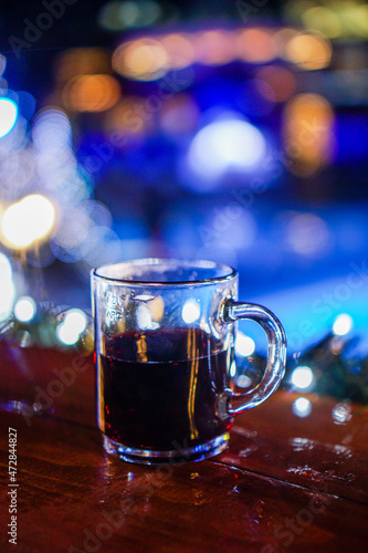 Gluhwein on wooden table with bokeh background