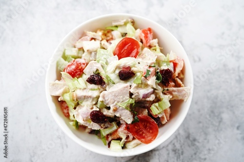 Homemade Chicken salad in a white bowl, selective focus