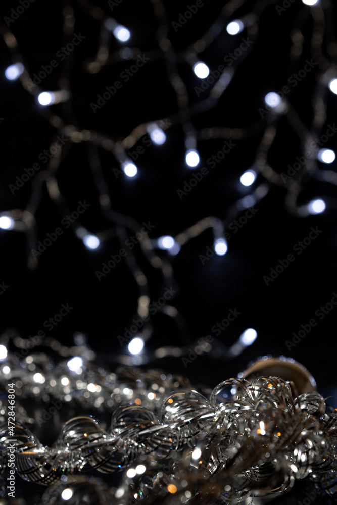 Silver Christmas decorations, garlands and balloons. Christmas decorations and garlands create a festive atmosphere. Merry Christmas and Happy New Year.