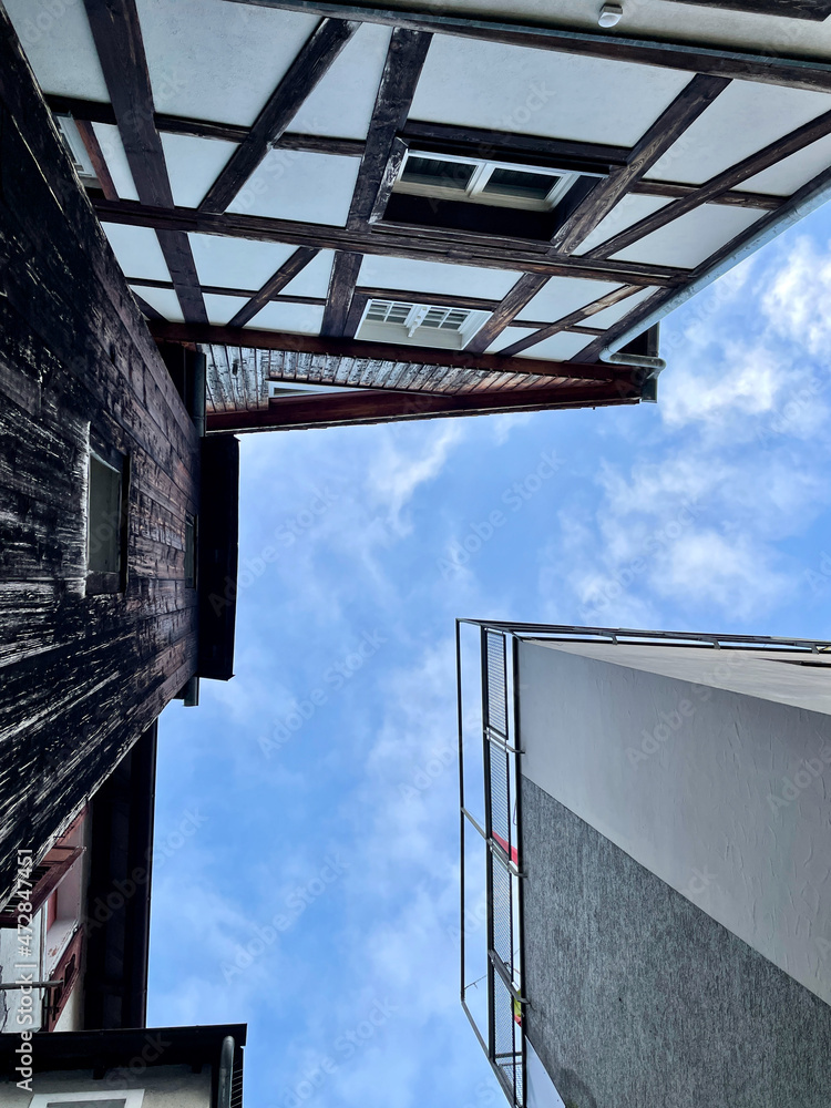 Facades of old and new buildings in Feldkirch, Vorarlberg, Austria. Low angle view. Facades of old and new buildings in Feldkirch, Vorarlberg, Austria. Low angle view.