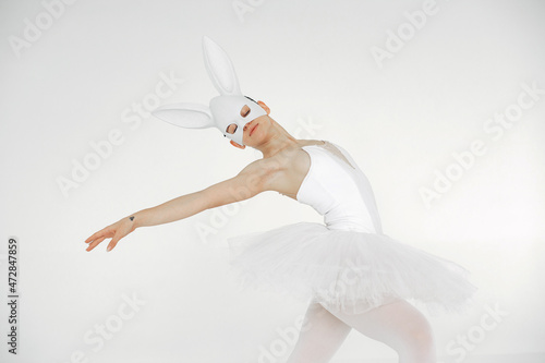 Fototapeta Naklejka Na Ścianę i Meble -  Ballerina posing in front of white background