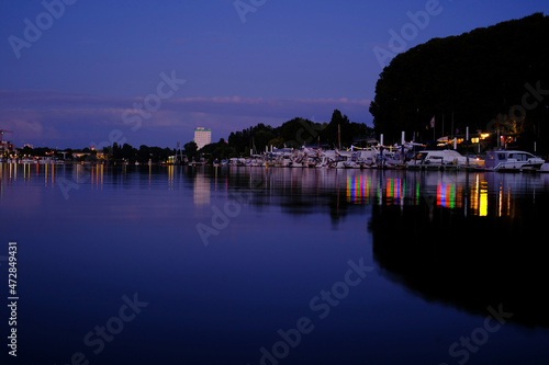 beautiful sea, river landscape with boats and yachts on the Wiesbaden pier in Germany, evening lights and reflections in the water, the concept of water travel, water sports
