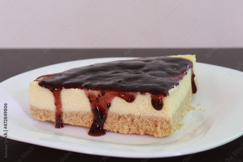 A piece of cheese cake with blackberry cream A piece of cheese cake with blackberry cream