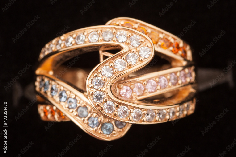 Gold ring with diamonds on dark background. Engagement ring Gold ring with diamonds on dark background. Engagement ring