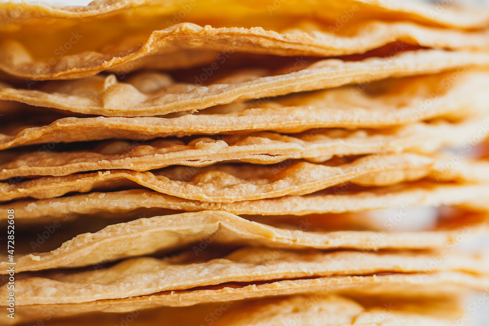 Layers of baked crumpets cakes made of puff pastry for cake. Semi-finished product for cake. Layers of baked crumpets cakes made of puff pastry for cake. Semi-finished product for cake.