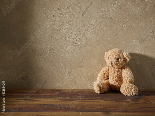 old teddy bear on a wooden shelf