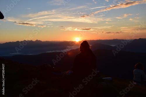 sunset with a person sitting infant of it