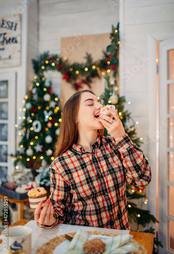girl eating sweet desserts in christmas decorated room