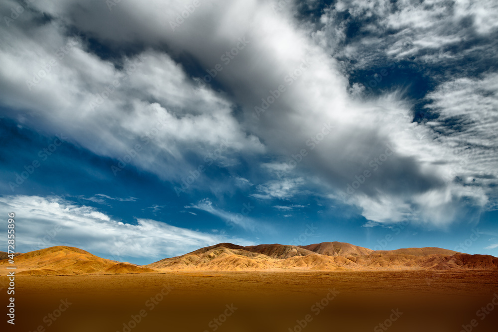 Cloudscape over eroded hills in the Atacama desert in the north of Chile
