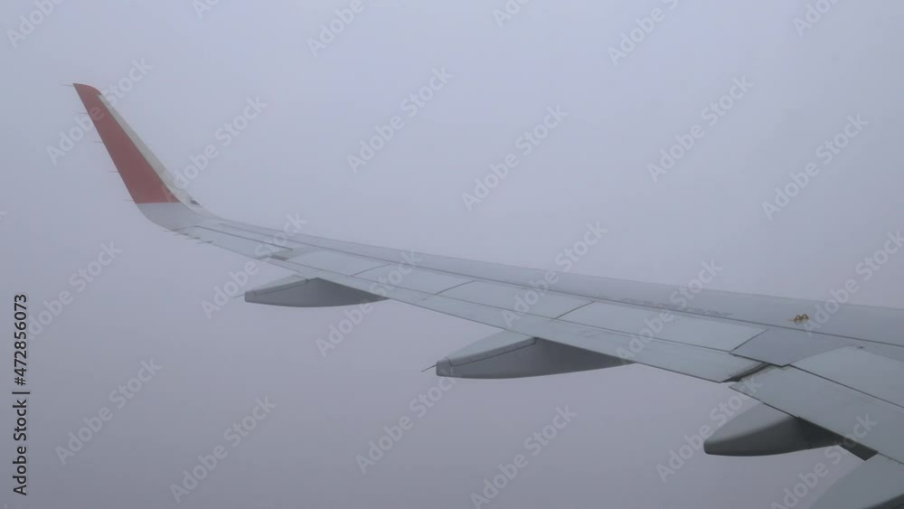 The descent of the plane from the dark clouds from the thickest darkness into the clouds below. The descent of the plane from the dark clouds from the thickest darkness into the clouds below.