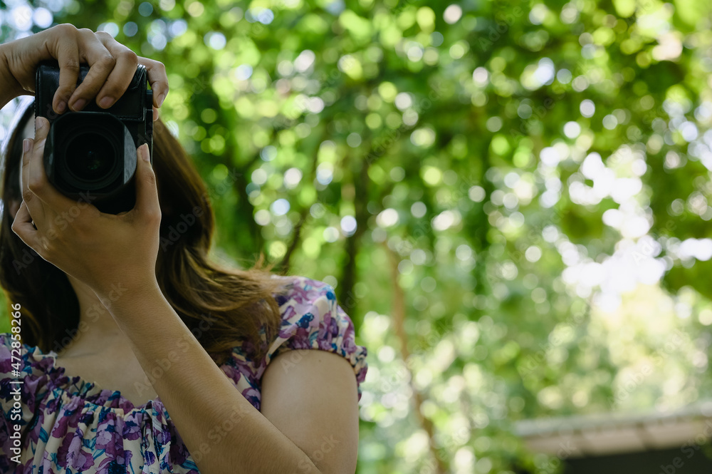 Young woman using camera with beautiful bokeh , learning , travel and recreation concept Young woman using camera with beautiful bokeh , learning , travel and recreation concept