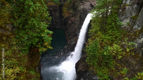 View of rocky waterfall in Elk Falls Provincial Park on Vancouver Island near Campbell River, British Columbia, Canada in autumn season surrounded by dense vegetation. photo