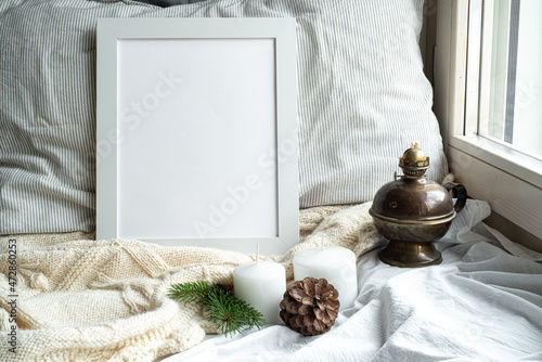 Wallpaper Mural Cozy winter home interior scene.Christmas composition near the window.Blank white picture frame mockup, oil lamp, candles,pine cone.Model for Christmas menu. Torontodigital.ca