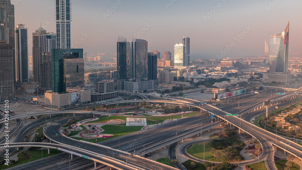 Highway crossroad and office buildings in Dubai Internet City and Media City district aerial timelapse