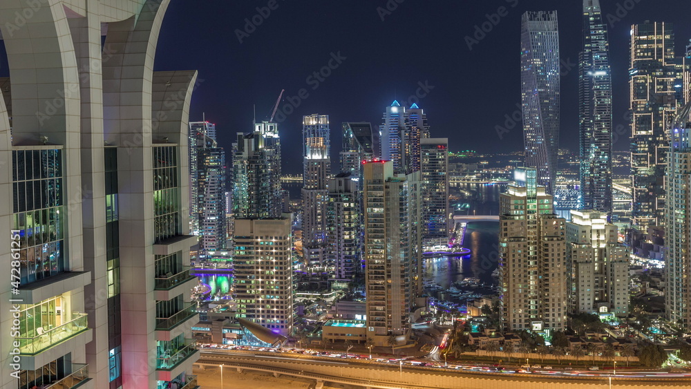 Fototapeta premium Skyscrapers of Dubai Marina near intersection on Sheikh Zayed Road with highest residential buildings night timelapse