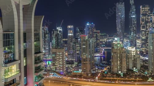 Skyscrapers of Dubai Marina near intersection on Sheikh Zayed Road with highest residential buildings night timelapse