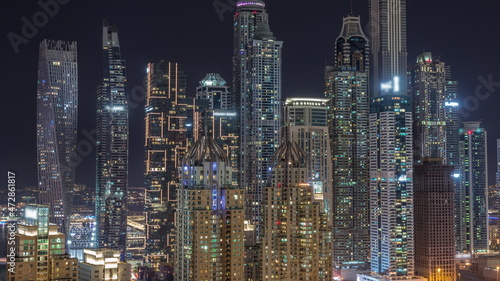 Skyscrapers of Dubai Marina near Sheikh Zayed Road with highest residential buildings all night timelapse
