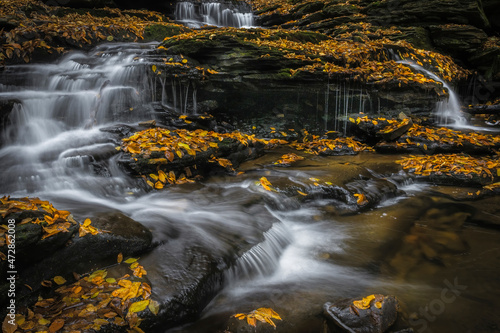 USA, Pennsylvania, Ricketts Glen State Park. Waterfalls cascade over rocks. photo