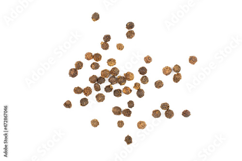 Lot of whole spicy black pepper isolated on white background