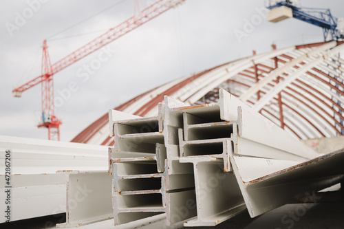 I-beam steel painted white lay piles on concrete, Raw materials used in building construction. Steel structure construction, Photo of I-beam used in steel frame construction. I-beam steel.