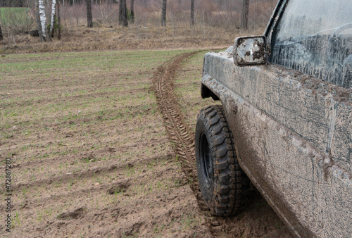 photograph of a wheel and auto parts. wheel mark on the field photo