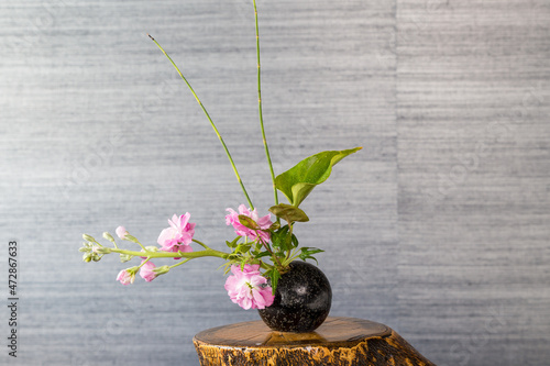 Ikebana , Japanese flower arrangement, simply putting flowers in a container. 