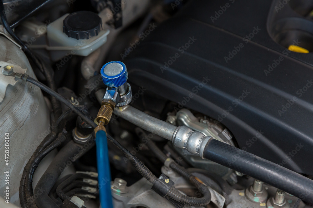 Auto mechanic monitor to check and fixed car air conditioner system in car garage. service car air conditioner in repair workshop. monitor tool on car engine ready to check and fixed air conditioner Auto mechanic monitor to check and fixed car air conditioner system in car garage. service car air conditioner in repair workshop. monitor tool on car engine ready to check and fixed air conditioner