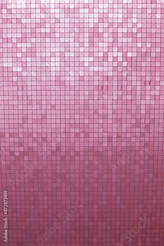 Pink glittering sequin background. Holiday decoration with sparkle sequin texture. Vertical orientation