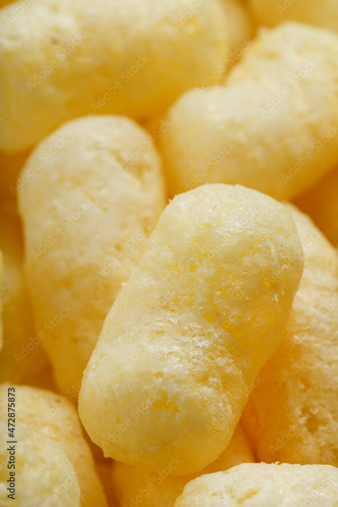 Golden corn sticks in powdered sugar close-up. Golden corn sticks in powdered sugar close-up.