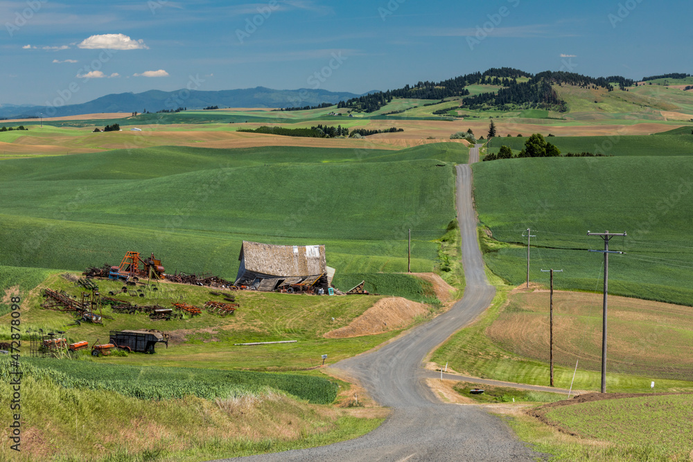 Elevated view of rural road and abandoned schoolhouse, Palouse region of eastern Washington.