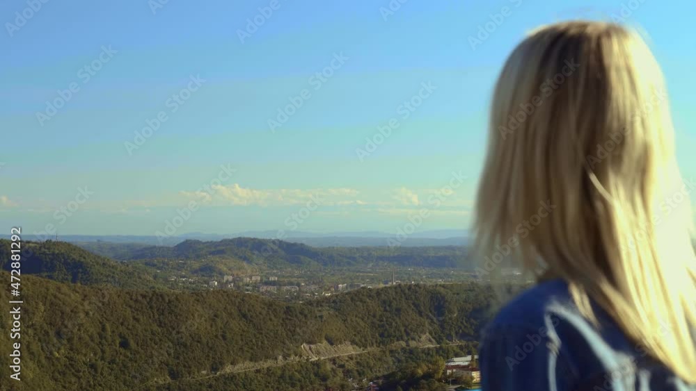 free, happy young woman traveler in denim jacket, looking into distance at mountains and valley with clouds from height standing on hill, breathing fresh air, Mountains, concept of freedom, Happiness free, happy young woman traveler in denim jacket, looking into distance at mountains and valley with clouds from height standing on hill, breathing fresh air, Mountains, concept of freedom, Happiness