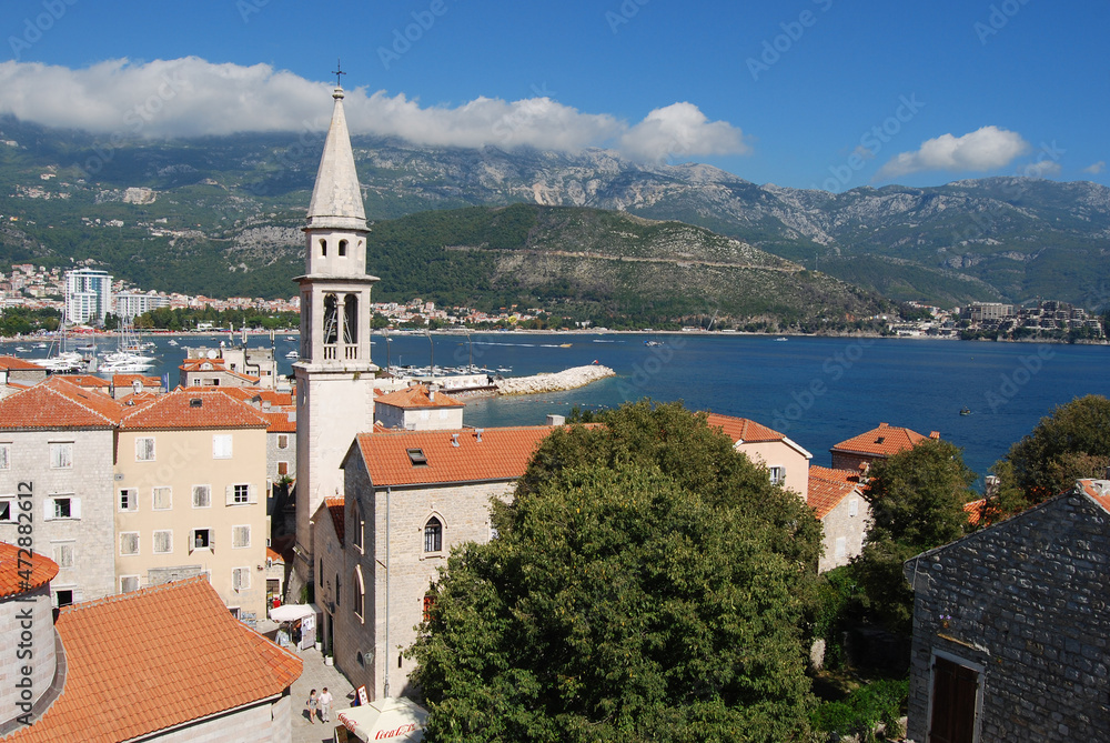 The embankment of Montenegro. Buildings on the coastline. Houses with red roofs. Old architecture Montenegro. Adriatic sea. Famous travel destination.