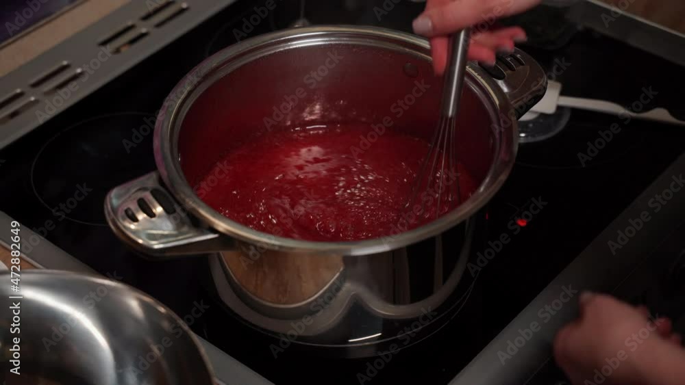 Stepbystep process of preparing syrup for Christmas cake. Red confetyur is cooked on an