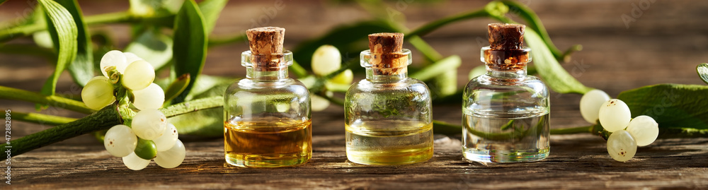 Panoramic banner or header with essential oils and mistletoe Panoramic banner or header with essential oils and mistletoe