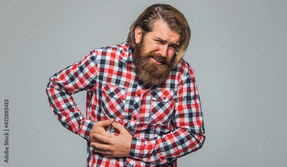 Bearded man with Stomach ache. Male with abdominal pain. Sick guy with stomachache. Health problem. Bearded man with Stomach ache. Male with abdominal pain. Sick guy with stomachache. Health problem.