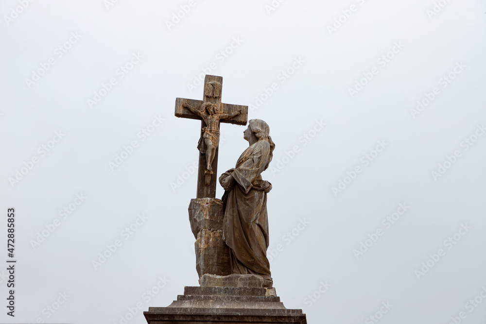 Woman facing the cross of Christ