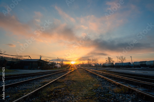 Two railways lit in sunrise colors