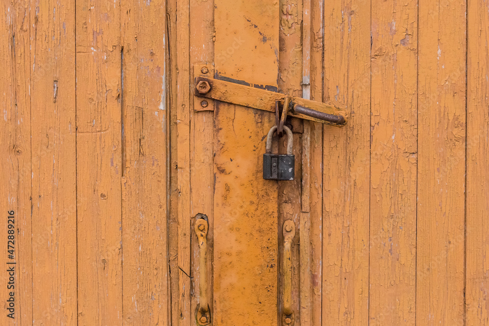 Old orange or brown wooden door with lock closed exit vintage antique background Old orange or brown wooden door with lock closed exit vintage antique background