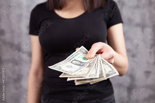 young woman holding dollar bills