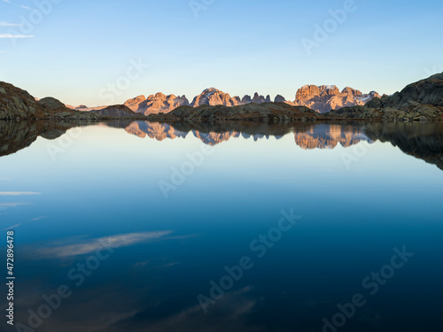 The summits of Brenta mountain range are reflected in Lago Nero. Brenta group in the Dolomites, part of UNESCO. Europe, Italy, Val Rendena