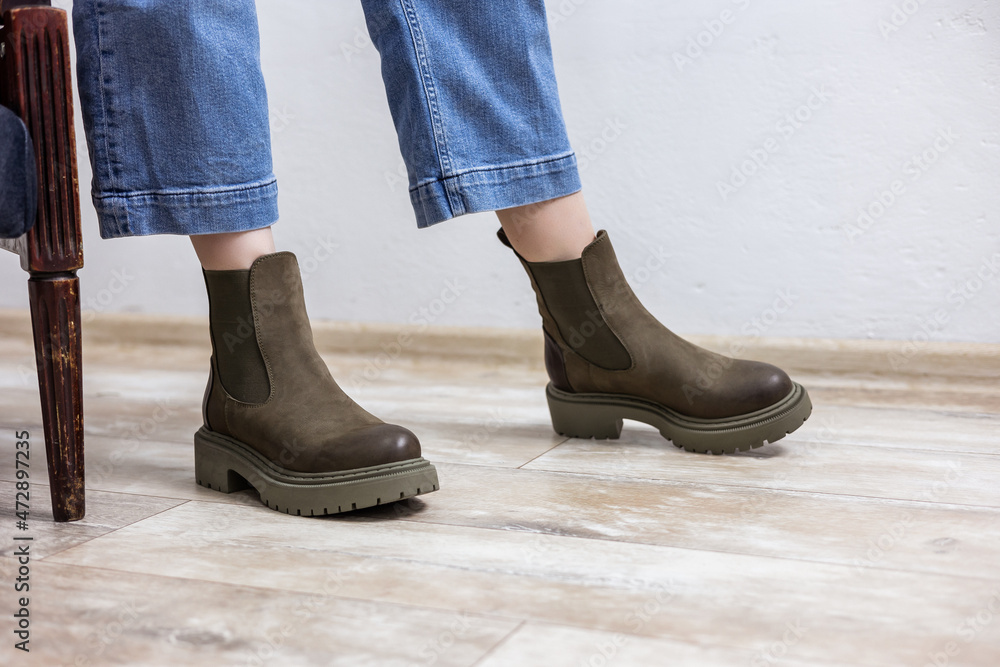 Beautiful female legs in leather boots and jeans. Female legs in fashionable boots Beautiful female legs in leather boots and jeans. Female legs in fashionable boots