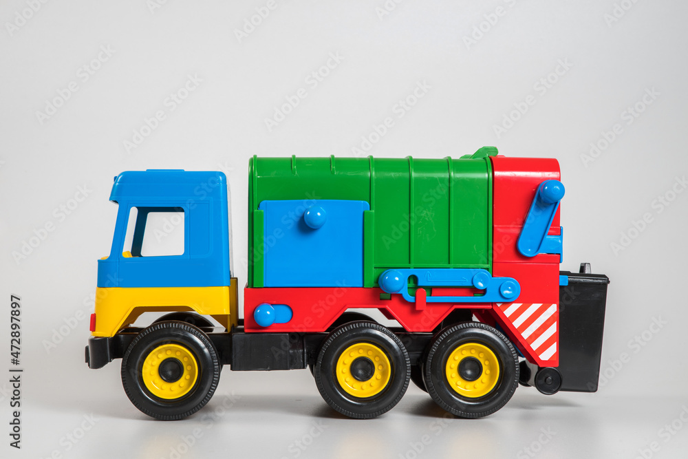 Multi-colored plastic children's toy cars on a white background. Multi-colored plastic children's toy cars on a white background.