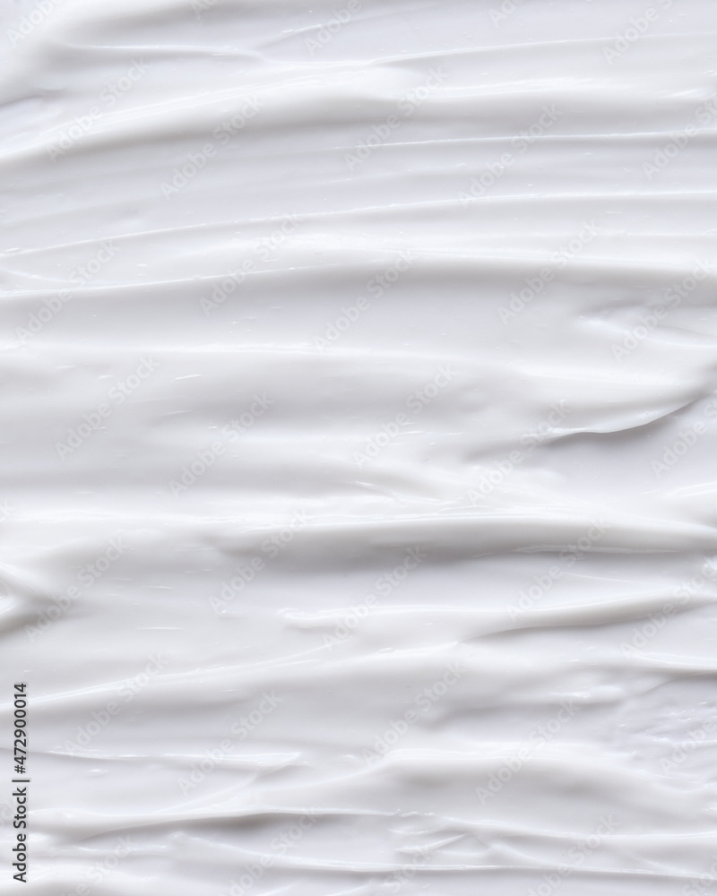 Obraz premium Cosmetics white face cream texture smudged with fingers