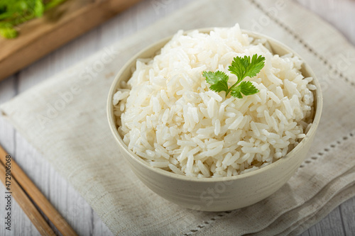 Bowl with cooked rice on the table. photo