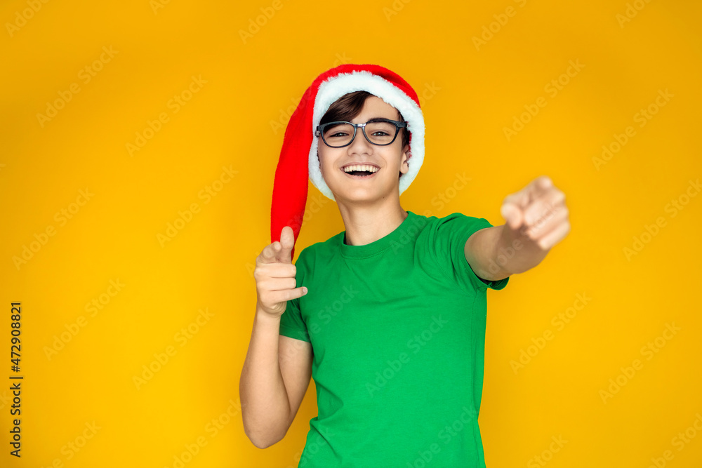 Happy teen in Santa hat on New Year's Eve Happy teen in Santa hat on New Year's Eve