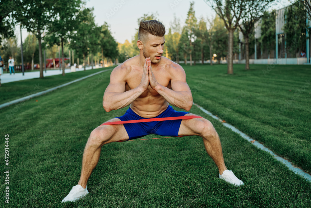 athletic man working out in the park crossfit exercise athletic man working out in the park crossfit exercise