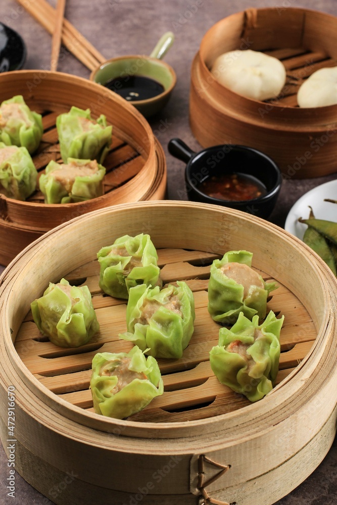 Close Up Vegetable Shumai with Green Skin Color, Steamed Dim Sum Dumpling on Bamboo Steamer Close Up Vegetable Shumai with Green Skin Color, Steamed Dim Sum Dumpling on Bamboo Steamer