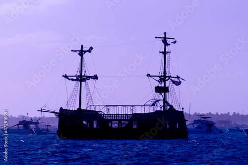 Old style ship silhouette at sunrise in the Caribbean, Punta Cana, Dominican Republic