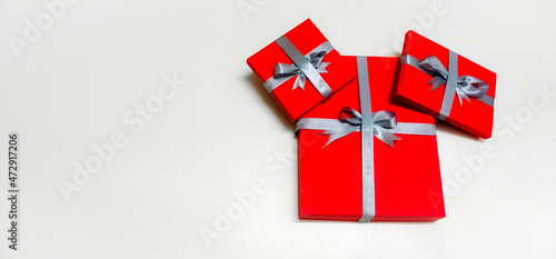 Closeup of Christmas Gift boxes wrapped with rippon decorated in a isolated White background with selective soft focus and copy space for inscription. Merry Christmas. photo